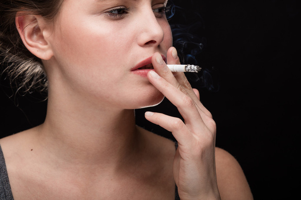 woman smoking concept on black - Фото, зображення