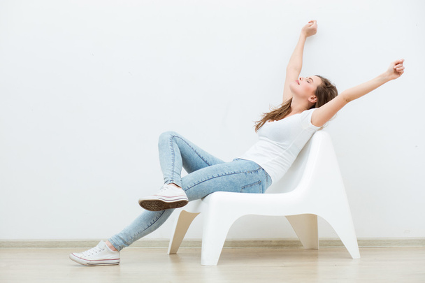 single woman sitting on white chair  - Φωτογραφία, εικόνα