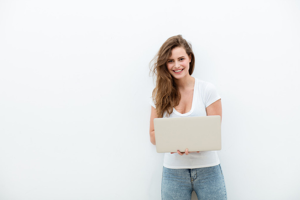 young woman holding a laptop on white - Fotó, kép