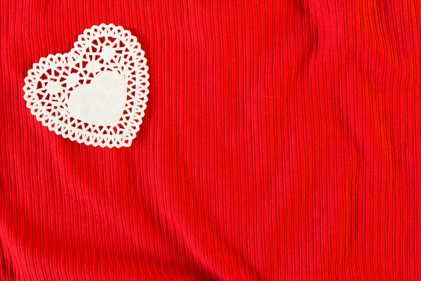 Paper cut white heart on red knitwear background - Photo, Image