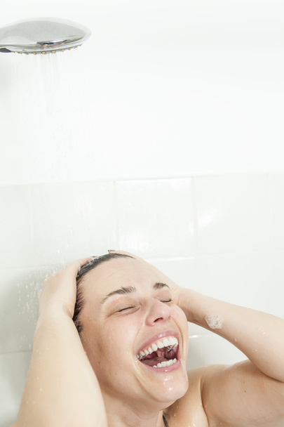 Shower woman. Happy smiling woman washing shoulder showering in - Zdjęcie, obraz