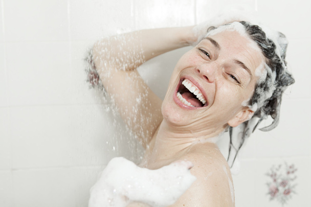 Shower woman. Happy smiling woman washing shoulder showering in - Fotoğraf, Görsel