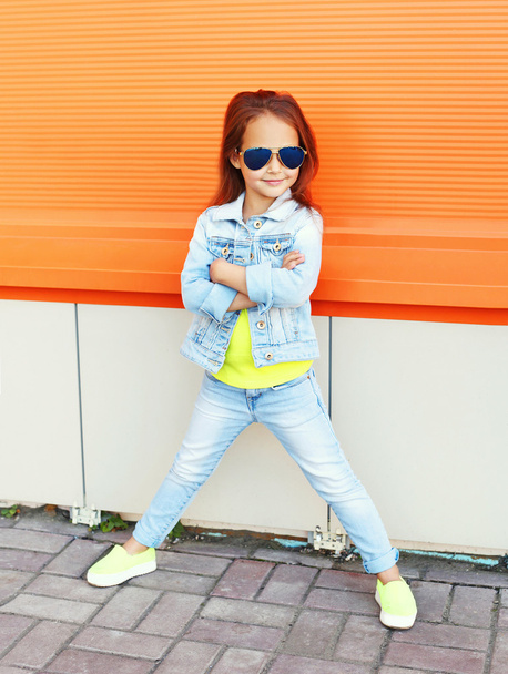 Beautiful little girl child wearing a sunglasses and jeans cloth - Foto, immagini