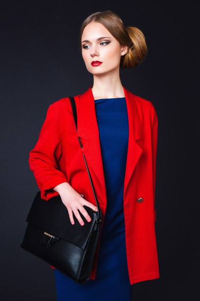 Beautiful young fashion business woman on black background - 写真・画像