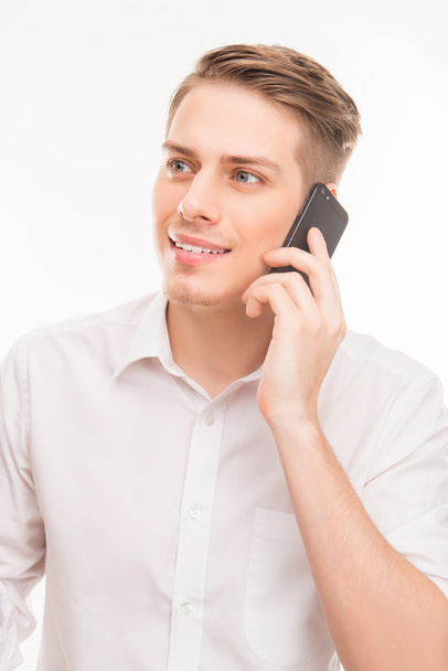 portrait of pretty young businessman talking on his smartphone - Фото, изображение