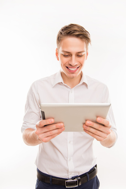 Pretty young businessman holding tablet and reading news - Foto, Imagem