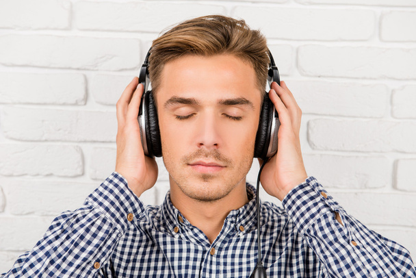 stylish man listening to music on headphones - Foto, Imagem