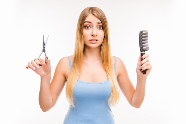 Girl chooses scissors or comb, beauty or convenience, long hair  - Fotoğraf, Görsel