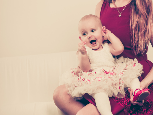 Happy baby girl on mother knees. - Foto, immagini