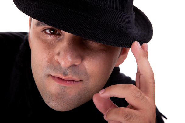 Portrait of a man with his black hat, isolated on white. Studio shot - Photo, Image