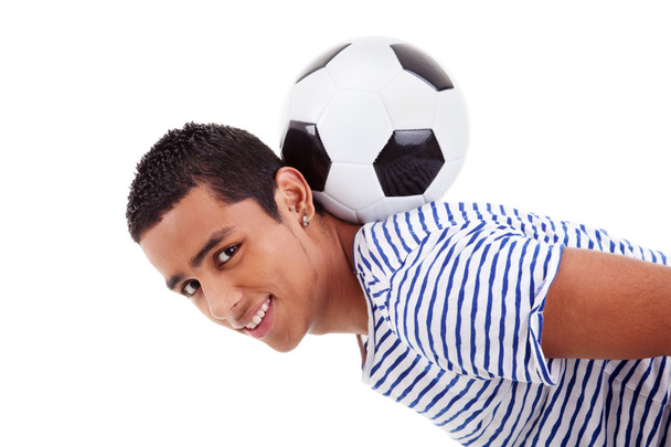 Handsome latin boy holding a soccer ball, isolated on white, studio shot - Фото, изображение