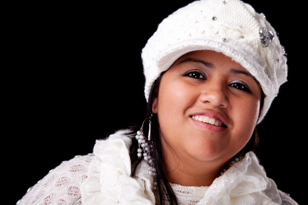 Portrait of a young latin woman smiling, in autumn and winter clothes, isolated on white. Studio shot - Photo, image
