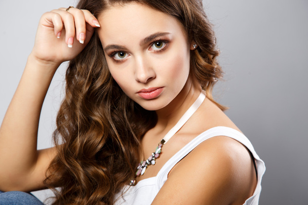 Close-up portrait of beautiful young woman with gorgeous hair and natural makeup. Fashion beauty photo - Photo, image