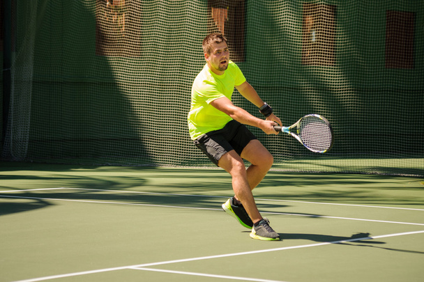 Man plays tennis in bright cloth   - Фото, изображение