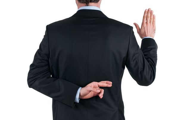 Jeune homme d'affaires en costume racontant un mensonge avec les doigts croisés
 - Photo, image