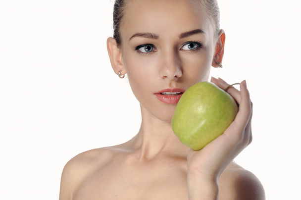 Girl holds a big green apple in front of her face.  - Photo, image