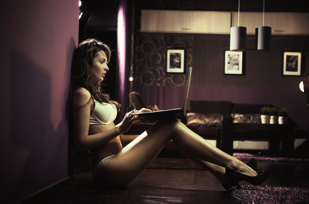 Sexy lady browsing internet late night - Photo, image