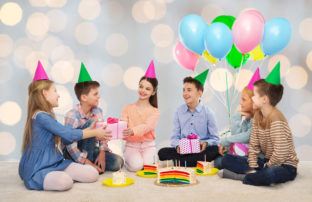 happy children giving presents at birthday party - Fotó, kép