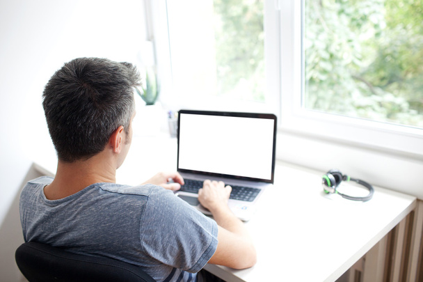 Young man working on laptop - Foto, Imagen