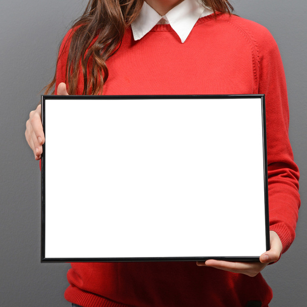 Woman holding empty frame with space for your advertisement agai - Zdjęcie, obraz