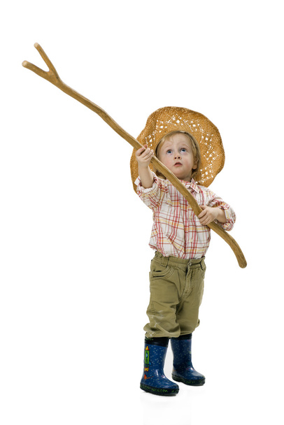 Country boy in a straw hat and a stick in his hands on a white background - Photo, Image