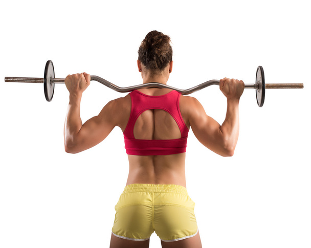 Muscular woman lifting an outrigger - Zdjęcie, obraz