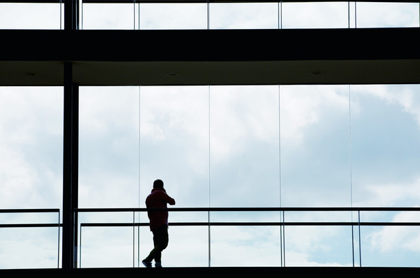 Silhouette view of young businessman in a modern office building interior - Foto, afbeelding
