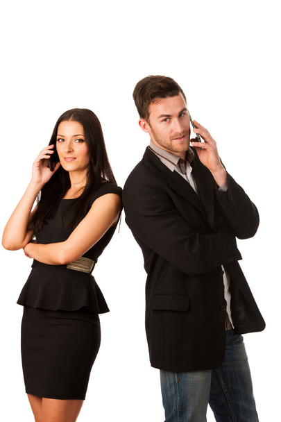 Business couple standing together and talking over phone, leanin - Photo, image