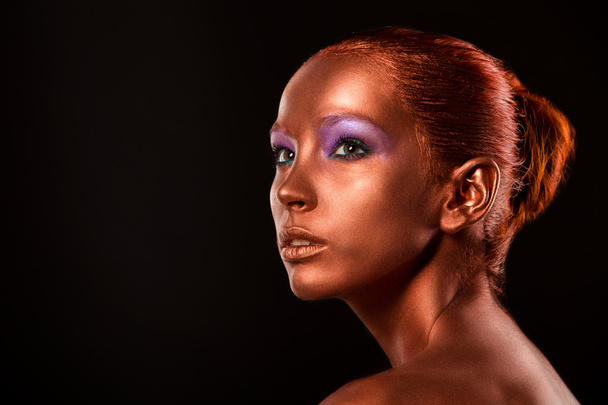 Gilt. Golden Womans Face Closeup. Futuristic Gilded Make-up. Painted Skin bronze. - Fotoğraf, Görsel