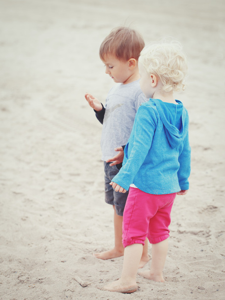 children on beach playing picking seashells - Фото, изображение