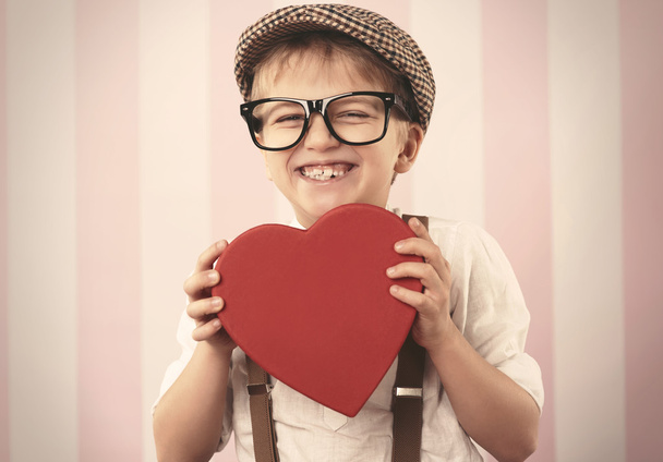 Boy holding a heart shaped box - Photo, Image