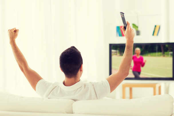 man watching sport channel on tv and at home - Foto, Imagen
