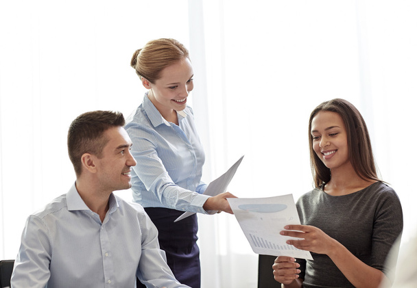 smiling business people with papers in office - Foto, immagini