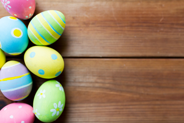 close up of colored easter eggs on wooden surface - Photo, Image