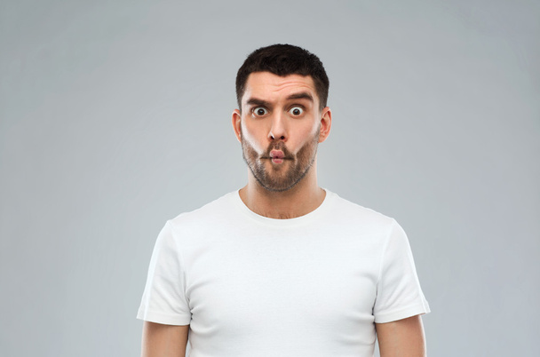 man with fish-face over gray background - Photo, Image