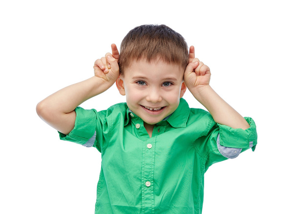 happy little boy having fun and making horns - Φωτογραφία, εικόνα