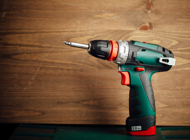 cordless screwdriver against wooden background - Photo, Image