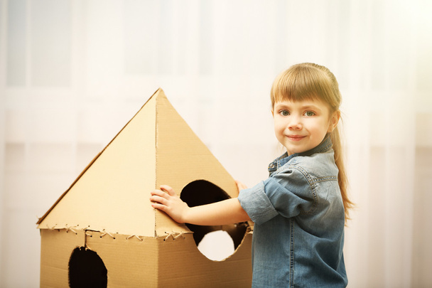 Girl playing with cardboard space rocket - Photo, image