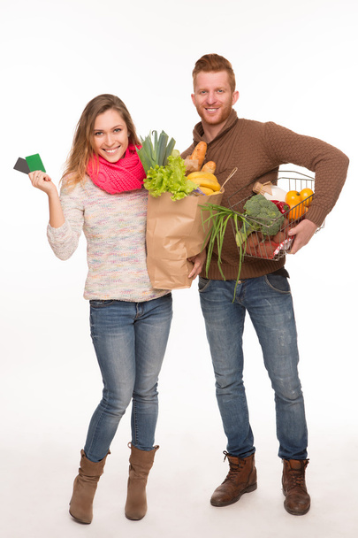 Happy couple with grocery shopping bags - Photo, Image