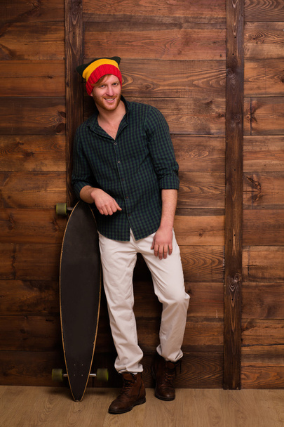 Hipster skateboarder in studio - 写真・画像