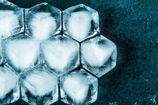 Honeycomb ice cubes on the dark stone table - Fotoğraf, Görsel