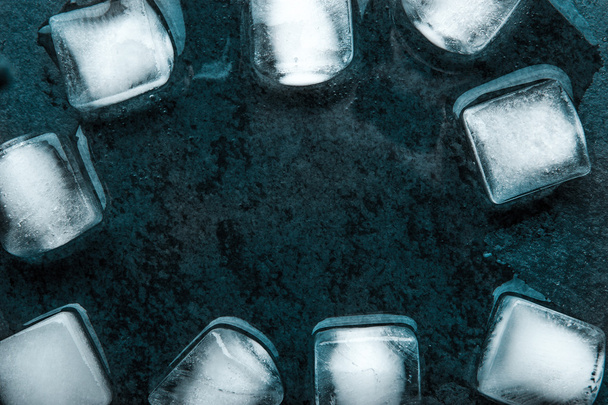 Frame of the ice cubes on the dark stone table - Fotoğraf, Görsel