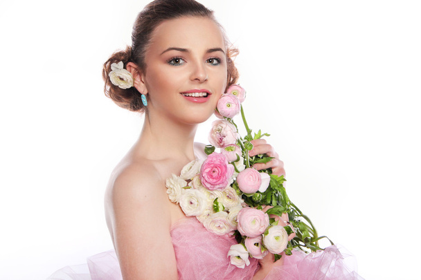 		Young beautiful woman with a bouquet of tender spring flowers  - Фото, зображення