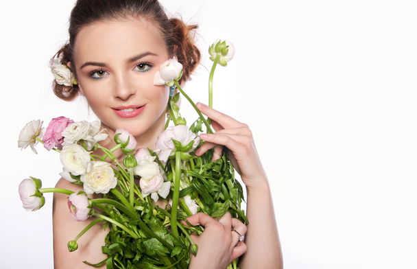		Young beautiful woman with a bouquet of tender spring flowers  - Foto, Imagem