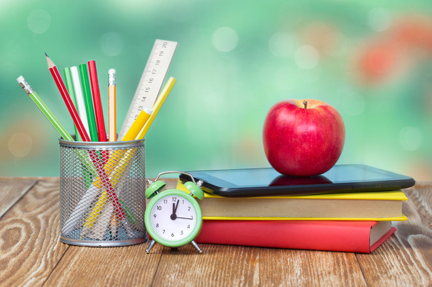 School supplies on green empty space background. - Photo, image