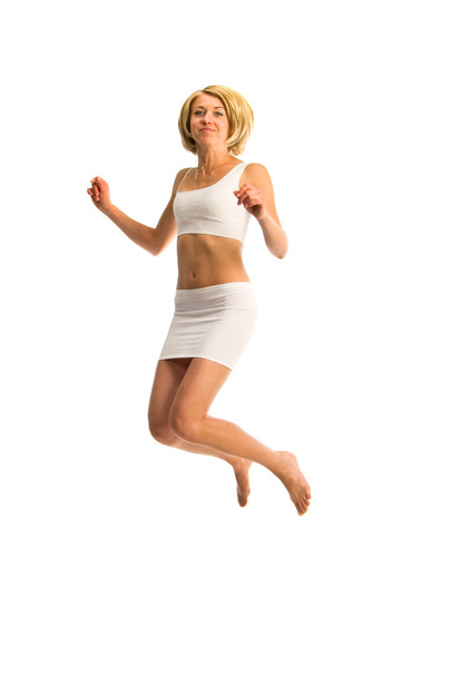 Casual woman jumping in joy ? isolated over a white background - Fotó, kép