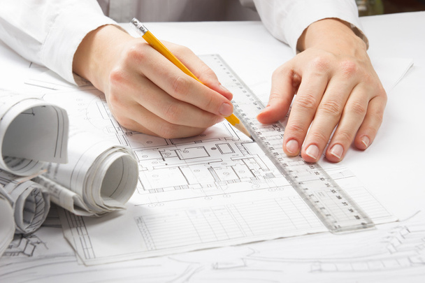 Architect working on blueprint. Architects workplace - architectural project, blueprints, ruler, calculator, laptop and divider compass. Construction concept. Engineering tools - Φωτογραφία, εικόνα