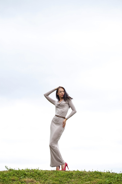Young woman in sexy long gray dress  - Valokuva, kuva