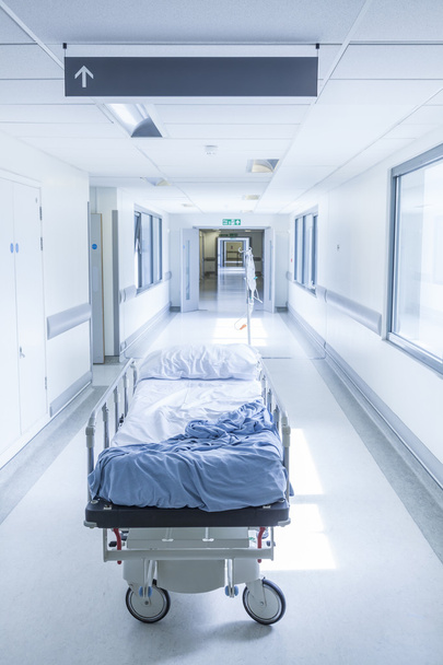 Empty Stretcher Bed Gurney in Hospital Corridor  - Photo, Image