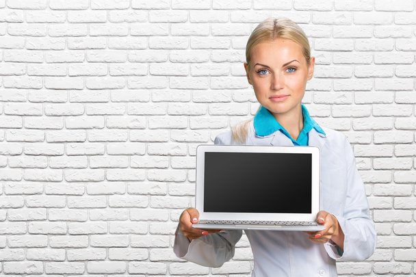 Nainen lääkäri jolla kannettava tietokone
 - Valokuva, kuva
